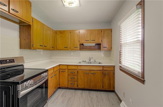 2917 N 83rd Ter, Kansas City, KS 66109 - kitchen featuring stainless steel range with electric cooktop, a sink, healthy amount of natural light, and light countertops