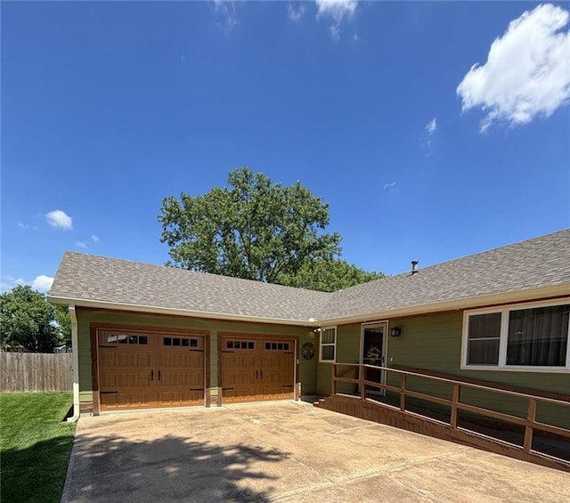 1205 W 14th Street Ct, Chanute, KS 66720 - view of front facade featuring a garage, concrete driveway, and a shingled roof