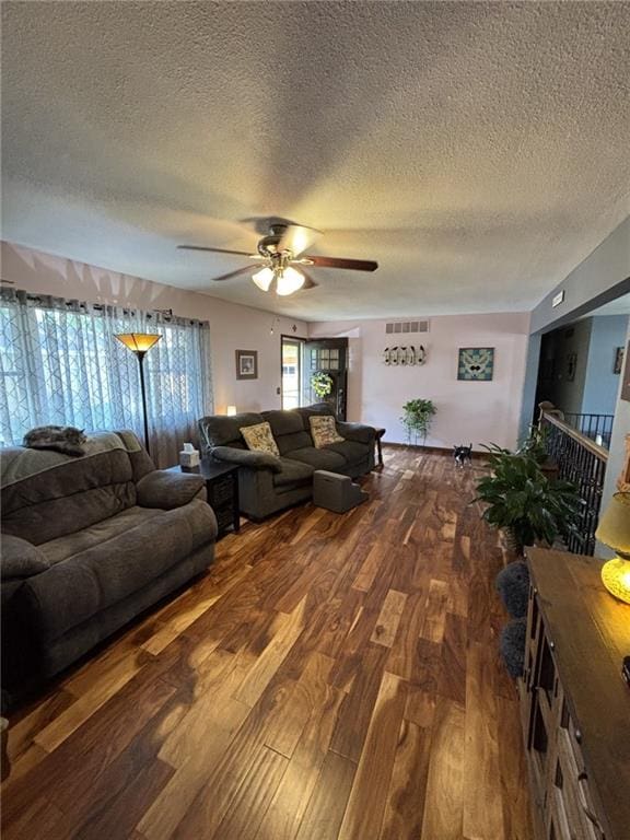 1205 W 14th Street Ct, Chanute, KS 66720 - living room with a textured ceiling, a ceiling fan, and wood finished floors
