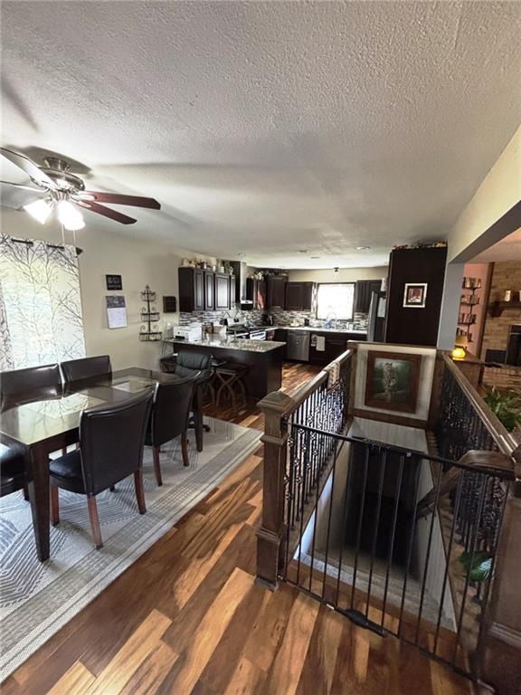 1205 W 14th Street Ct, Chanute, KS 66720 - dining area featuring wood finished floors, a textured ceiling, and ceiling fan
