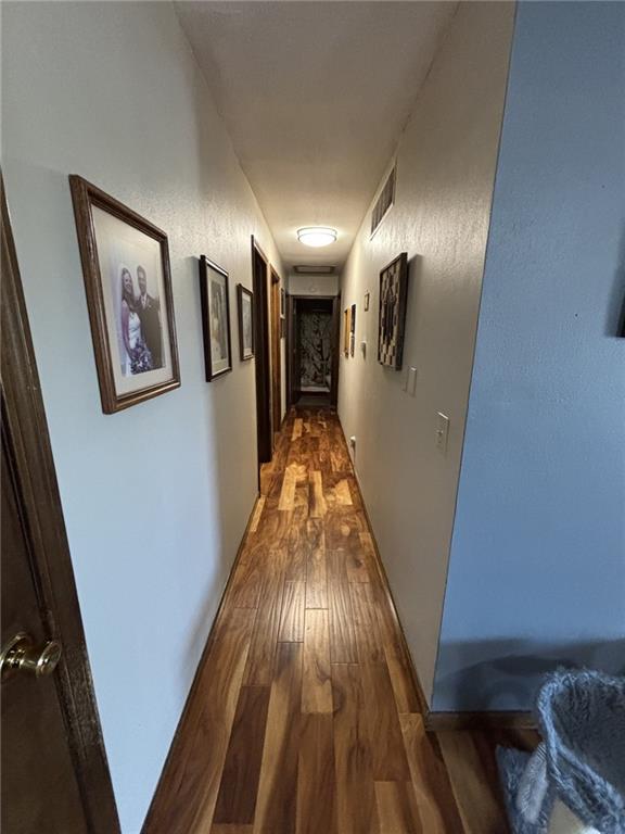1205 W 14th Street Ct, Chanute, KS 66720 - hallway featuring dark wood-style flooring