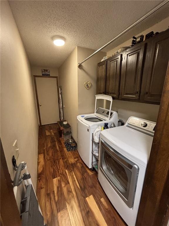 1205 W 14th Street Ct, Chanute, KS 66720 - washroom with washer and dryer, cabinet space, dark wood-type flooring, and a textured ceiling
