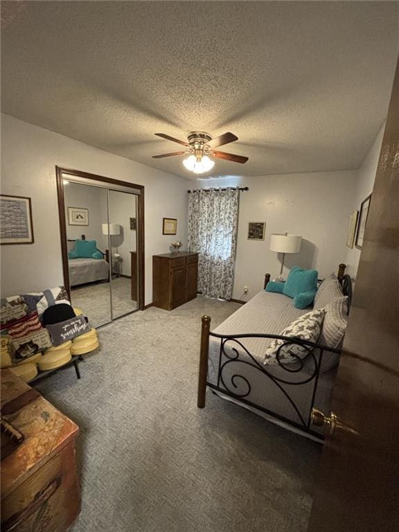 1205 W 14th Street Ct, Chanute, KS 66720 - carpeted bedroom with a closet, a textured ceiling, and a ceiling fan