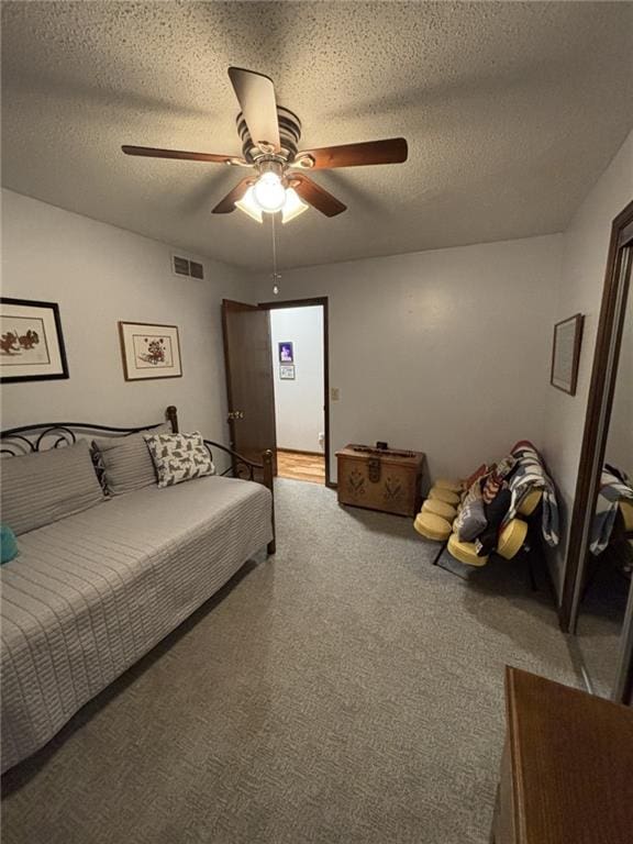 1205 W 14th Street Ct, Chanute, KS 66720 - carpeted bedroom with a textured ceiling and a ceiling fan