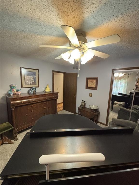 1205 W 14th Street Ct, Chanute, KS 66720 - rec room with a ceiling fan, carpet floors, and a textured ceiling