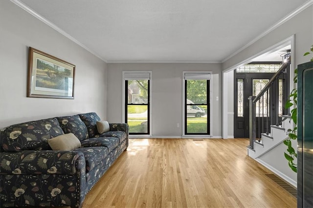 9327 Tomashaw Ln, Lenexa, KS 66219 - living area with wood finished floors, ornamental molding, and stairs
