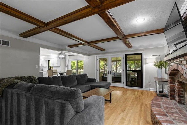 9327 Tomashaw Ln, Lenexa, KS 66219 - living room with coffered ceiling, a fireplace, beamed ceiling, and light wood-style flooring