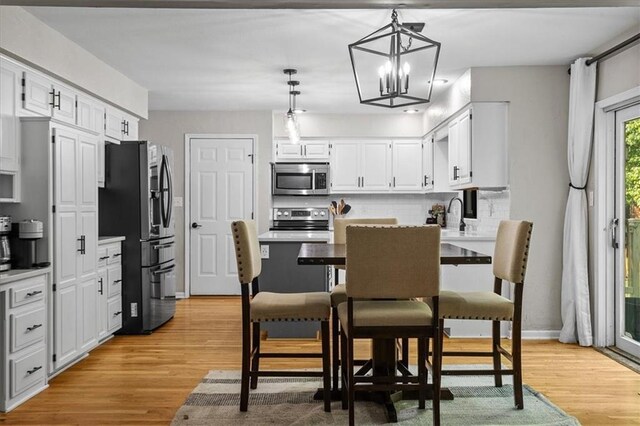 9327 Tomashaw Ln, Lenexa, KS 66219 - dining area featuring light wood-style floors and a chandelier