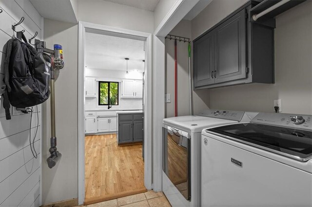 9327 Tomashaw Ln, Lenexa, KS 66219 - laundry room with cabinet space and washing machine and clothes dryer