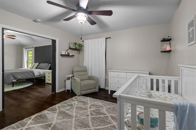 9327 Tomashaw Ln, Lenexa, KS 66219 - bedroom featuring wood finished floors, ceiling fan, and a crib