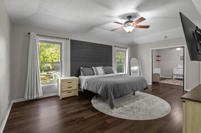 9327 Tomashaw Ln, Lenexa, KS 66219 - bedroom featuring a raised ceiling, multiple windows, dark wood-style flooring, and ceiling fan