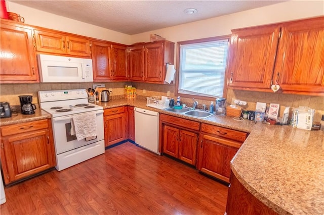 2802 N 39th Ter, Saint Joseph, MO 64506 - kitchen with white appliances, a sink, wood finished floors, brown cabinetry, and a textured ceiling