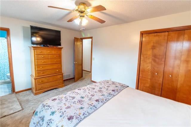 2802 N 39th Ter, Saint Joseph, MO 64506 - bedroom featuring a closet, carpet flooring, a ceiling fan, a textured ceiling, and baseboards