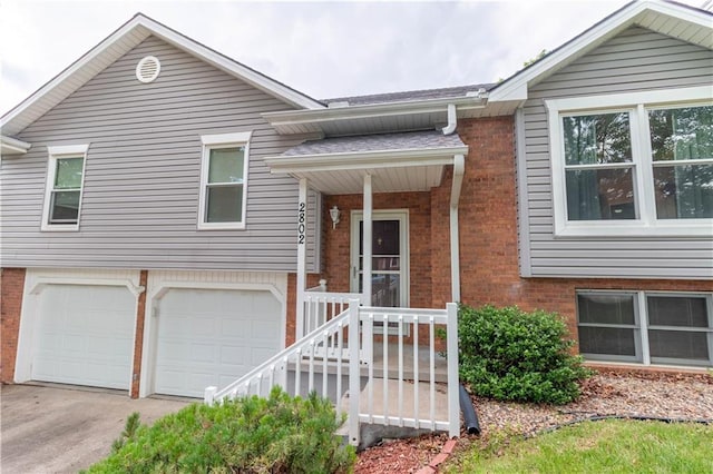 2802 N 39th Ter, Saint Joseph, MO 64506 - bi-level home featuring brick siding, an attached garage, and concrete driveway