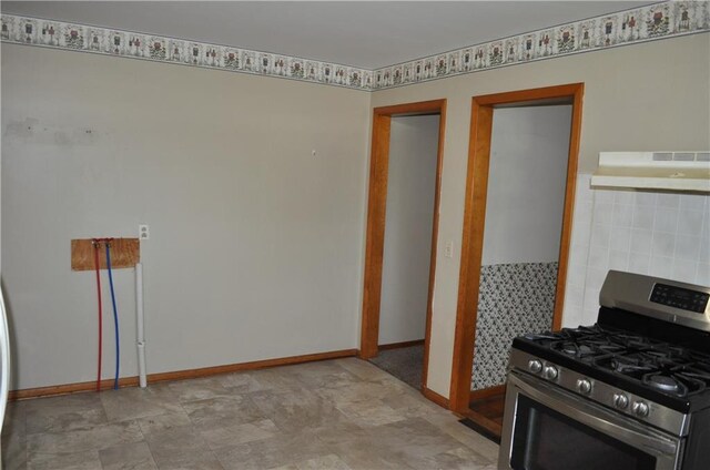 913 N Maple St, Stanberry, MO 64489 - kitchen with stainless steel range with gas cooktop, under cabinet range hood, and baseboards