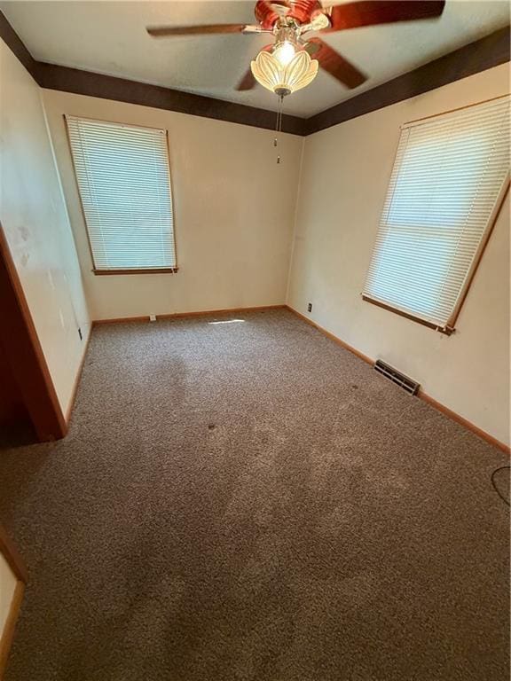 913 N Maple St, Stanberry, MO 64489 - spare room with a ceiling fan, carpet, and baseboards