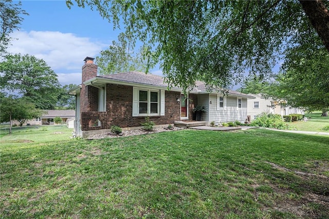 63 Maple Dr, Platte City, MO 64079 - ranch-style home with a chimney, a front lawn, and brick siding