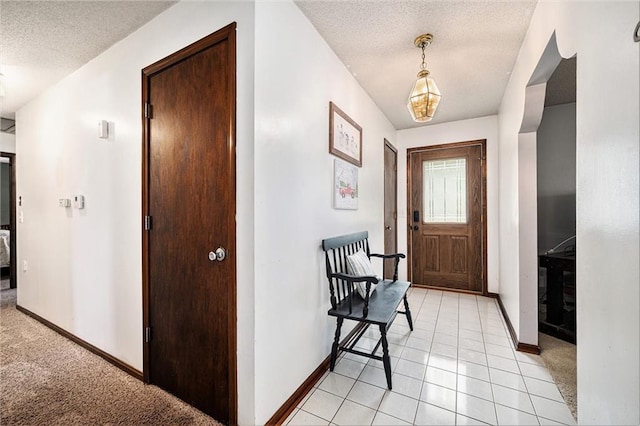 63 Maple Dr, Platte City, MO 64079 - entrance foyer featuring a textured ceiling and light tile patterned flooring