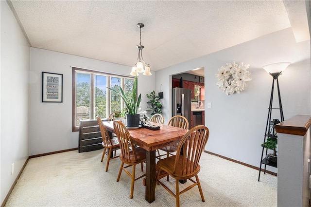 63 Maple Dr, Platte City, MO 64079 - dining area with a textured ceiling, light carpet, and a chandelier