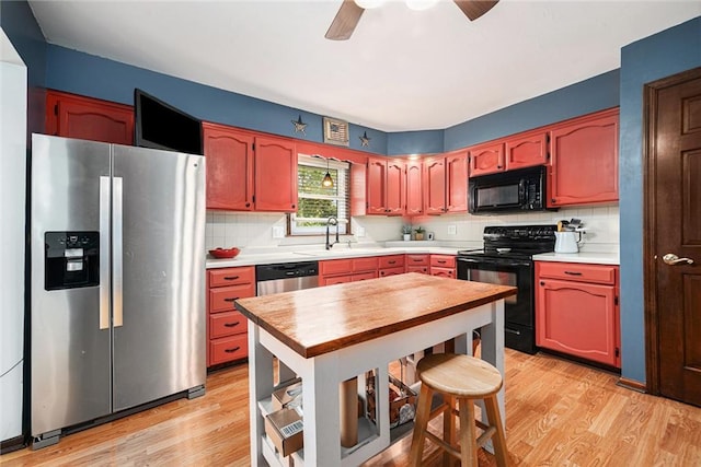 63 Maple Dr, Platte City, MO 64079 - kitchen featuring black appliances, light wood-style flooring, decorative backsplash, and a ceiling fan