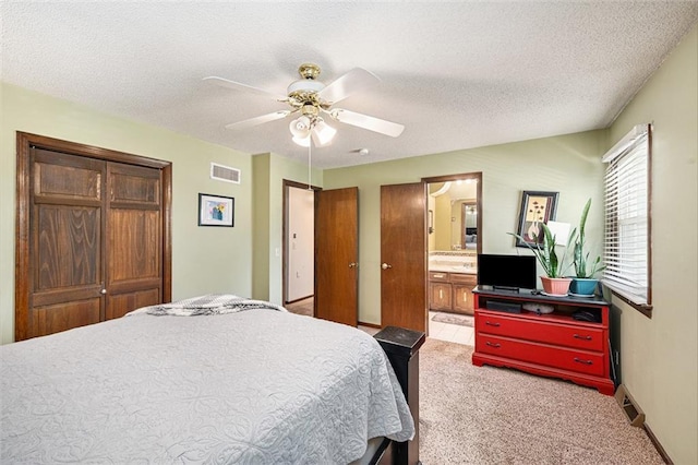 63 Maple Dr, Platte City, MO 64079 - bedroom with light colored carpet, a closet, ceiling fan, ensuite bath, and a textured ceiling