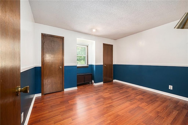 63 Maple Dr, Platte City, MO 64079 - unfurnished room featuring wood finished floors and a textured ceiling