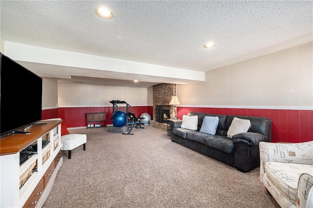 63 Maple Dr, Platte City, MO 64079 - carpeted living room with a wainscoted wall, wood walls, a fireplace, and a textured ceiling
