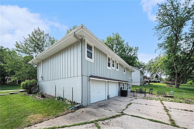 63 Maple Dr, Platte City, MO 64079 - view of side of property featuring board and batten siding, a yard, and a garage