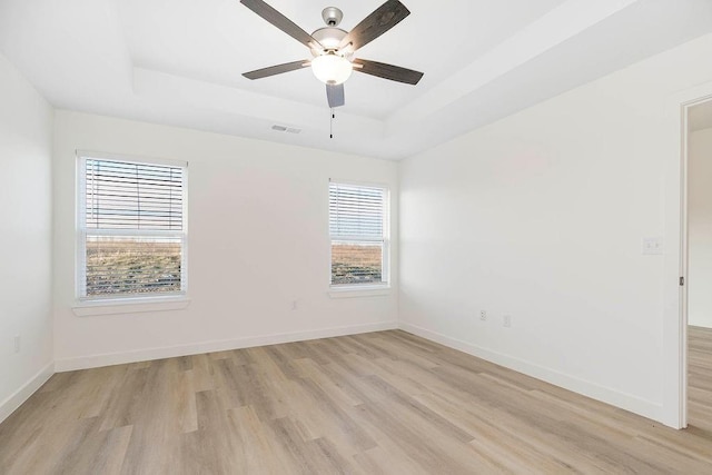 3818 NW 93rd St, Kansas City, MO 64154 - unfurnished room with a raised ceiling, plenty of natural light, and light wood-type flooring
