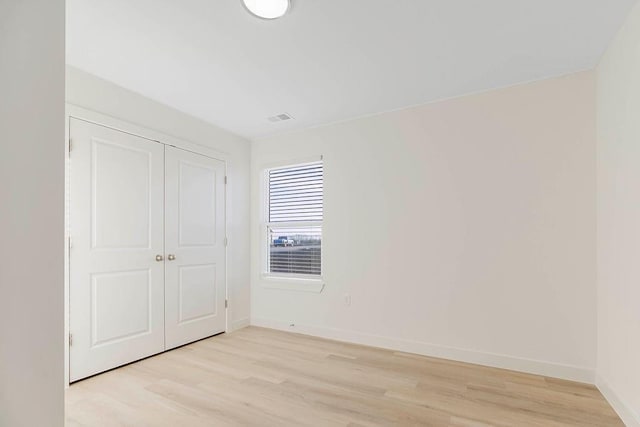 3818 NW 93rd St, Kansas City, MO 64154 - unfurnished bedroom featuring light wood-style floors, baseboards, and a closet
