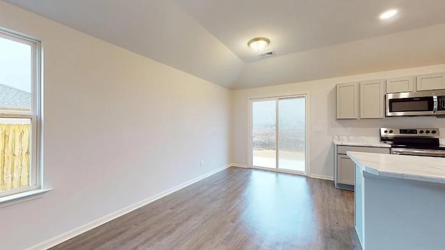 551 W Lanesfield St, Gardner, KS 66030 - kitchen featuring stainless steel appliances, wood finished floors, baseboards, light stone counters, and gray cabinetry