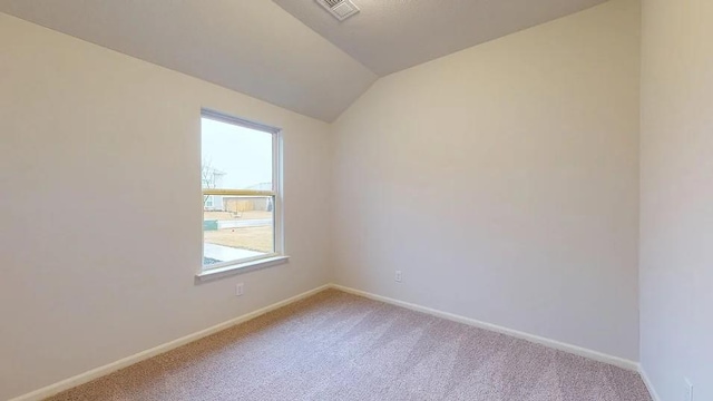 551 W Lanesfield St, Gardner, KS 66030 - empty room with light carpet, healthy amount of natural light, and vaulted ceiling