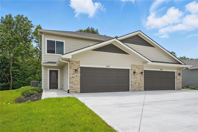 809 Highland Dr, Edwardsville, KS 66111 - view of front of home with a garage, driveway, a front yard, and cooling unit