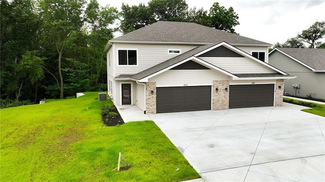 809 Highland Dr, Edwardsville, KS 66111 - view of front of home featuring a front yard, concrete driveway, an attached garage, and a shingled roof