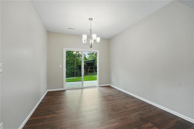 809 Highland Dr, Edwardsville, KS 66111 - spare room with dark wood finished floors, a chandelier, and baseboards