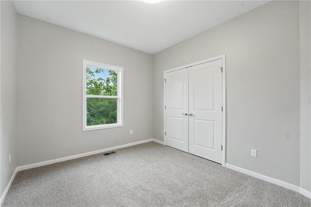 809 Highland Dr, Edwardsville, KS 66111 - unfurnished bedroom featuring carpet floors, baseboards, and a closet