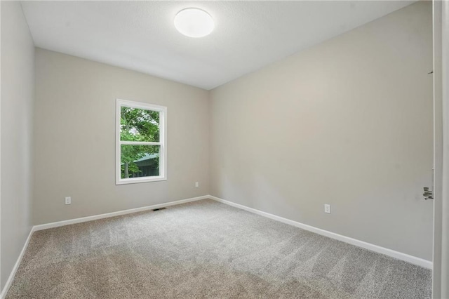 809 Highland Dr, Edwardsville, KS 66111 - carpeted spare room featuring baseboards