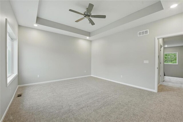 809 Highland Dr, Edwardsville, KS 66111 - empty room with carpet floors, recessed lighting, baseboards, a ceiling fan, and a tray ceiling