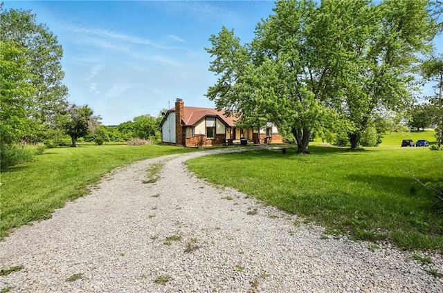 4613 SE Atchison Rd, Lathrop, MO 64465 - view of front facade featuring driveway, a front yard, and a chimney
