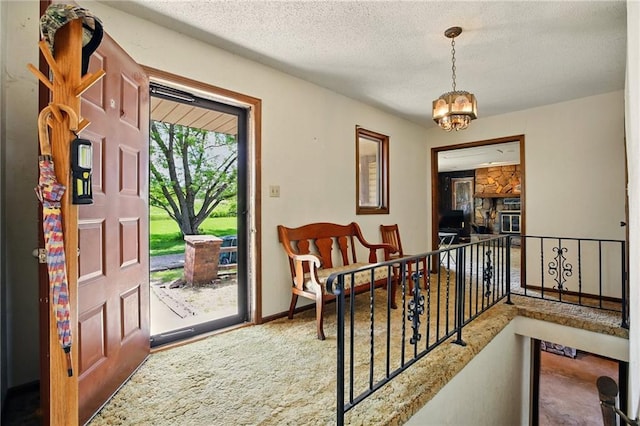 4613 SE Atchison Rd, Lathrop, MO 64465 - entryway with a textured ceiling, a chandelier, and carpet floors