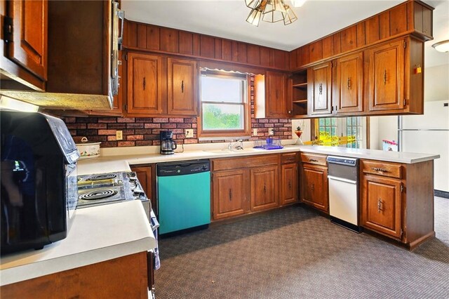 4613 SE Atchison Rd, Lathrop, MO 64465 - kitchen featuring dishwasher, dark carpet, freestanding refrigerator, a peninsula, and light countertops