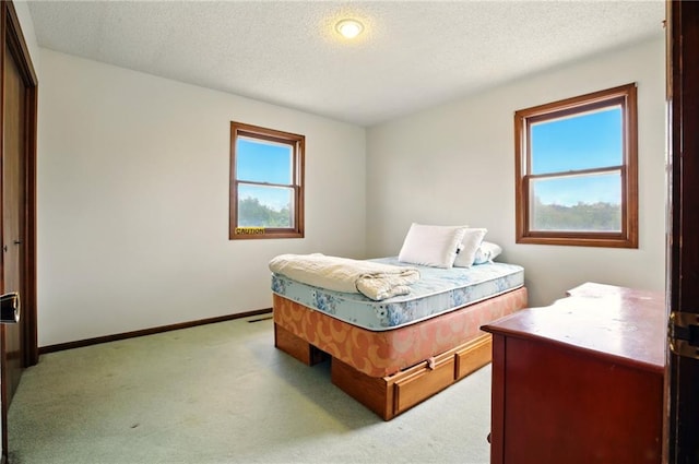 4613 SE Atchison Rd, Lathrop, MO 64465 - bedroom featuring light colored carpet, a textured ceiling, and baseboards