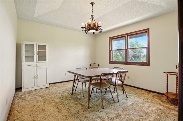 4613 SE Atchison Rd, Lathrop, MO 64465 - dining area with a chandelier, a textured ceiling, light carpet, and baseboards