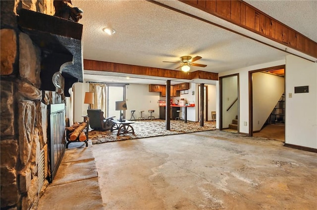 4613 SE Atchison Rd, Lathrop, MO 64465 - living area featuring a textured ceiling, stairs, concrete floors, and a ceiling fan