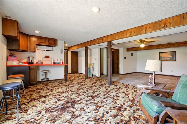 4613 SE Atchison Rd, Lathrop, MO 64465 - kitchen with carpet flooring, open floor plan, a textured ceiling, brown cabinetry, and a ceiling fan