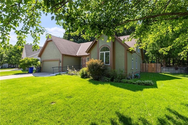 12484 S Hallet St, Olathe, KS 66062 - view of front of property featuring an attached garage, concrete driveway, and stucco siding