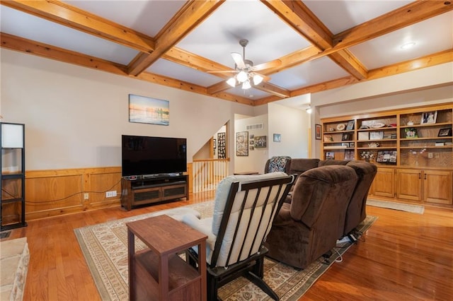 12484 S Hallet St, Olathe, KS 66062 - living room featuring beam ceiling, wood finished floors, coffered ceiling, a wainscoted wall, and a ceiling fan