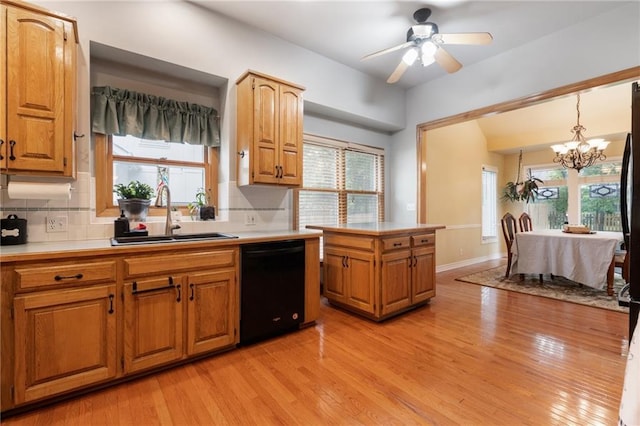 12484 S Hallet St, Olathe, KS 66062 - kitchen with black dishwasher, a sink, a chandelier, decorative backsplash, and light countertops