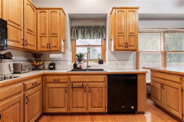 12484 S Hallet St, Olathe, KS 66062 - kitchen with black appliances, a sink, tasteful backsplash, and light wood-type flooring