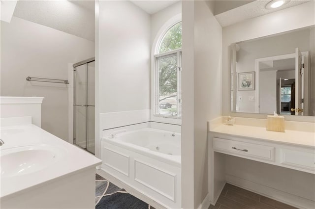 12484 S Hallet St, Olathe, KS 66062 - full bathroom with double vanity, a shower stall, a tub with jets, and wood finished floors
